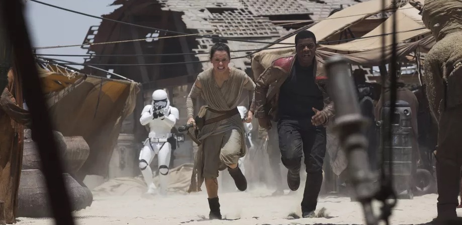 Finn and Rey running from a Stormtrooper.